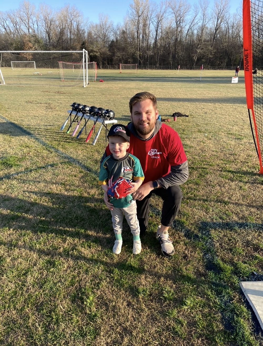 Cameron coaching his son's t-ball team